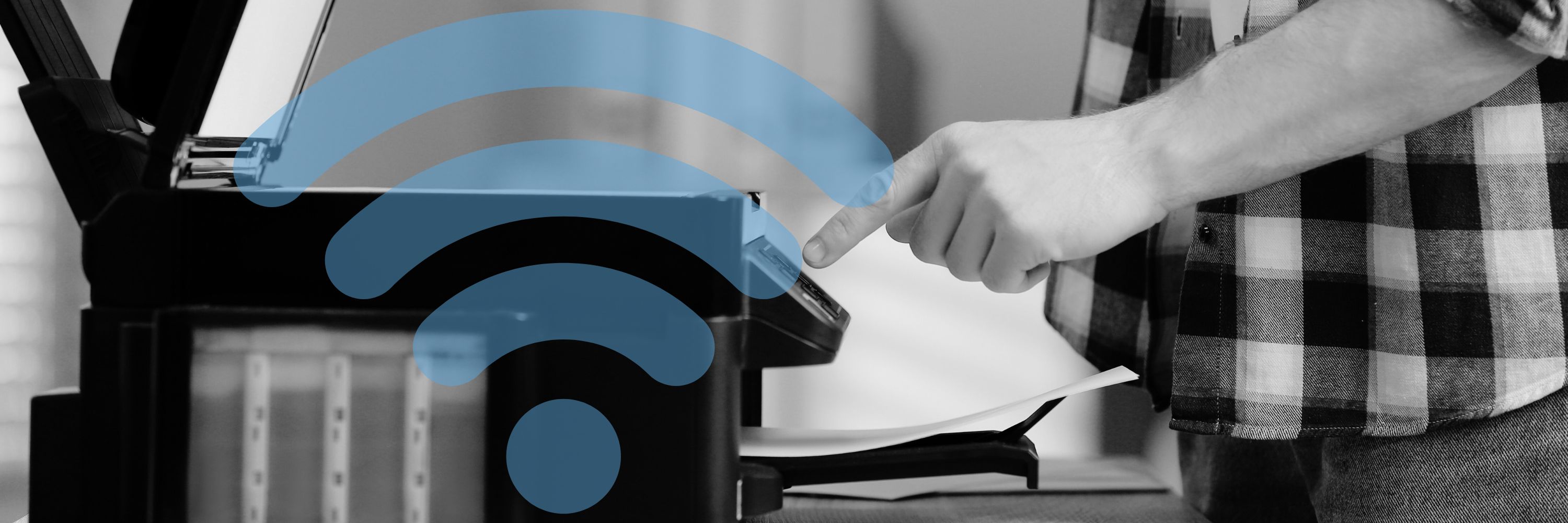 Man's hand pressing a button on a home printer