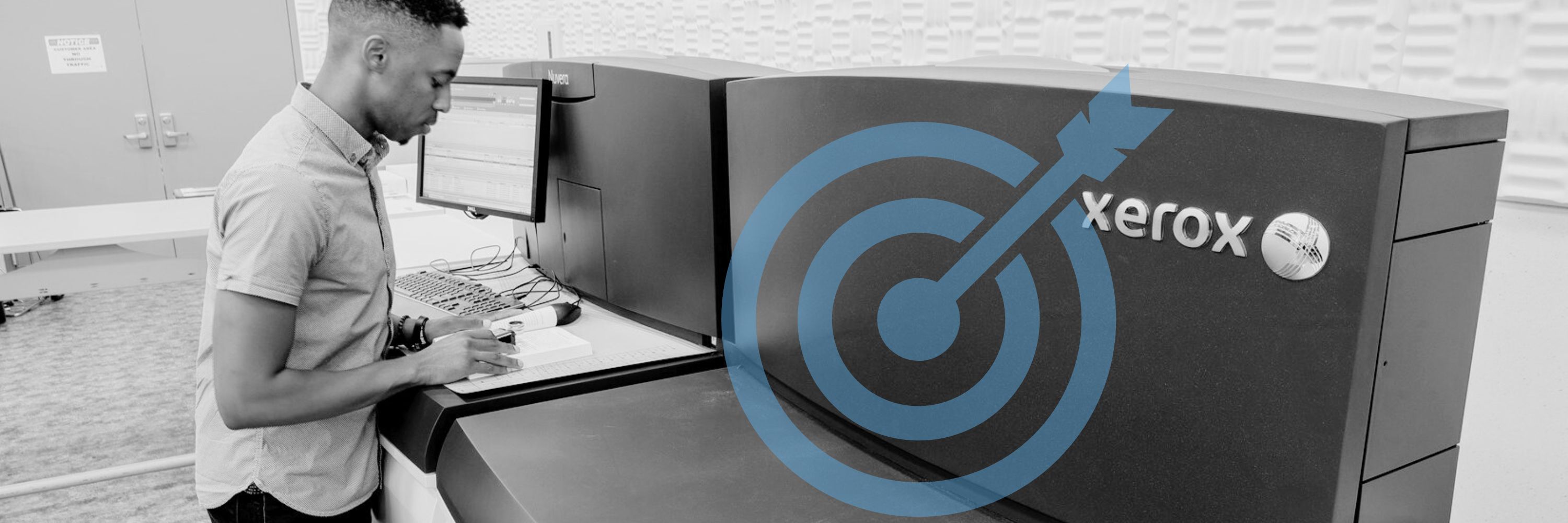 A man in front of a Xerox digital printing press