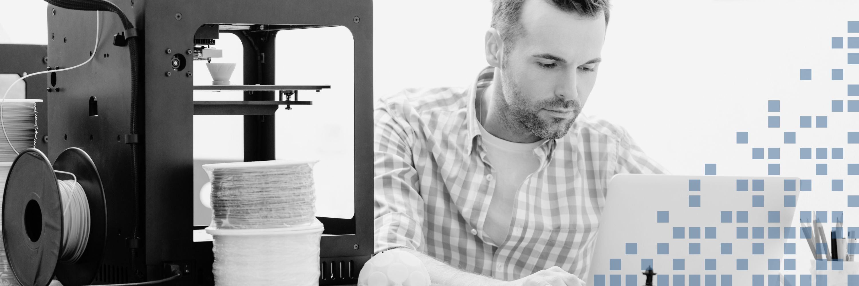 Man using a 3D printer and computer