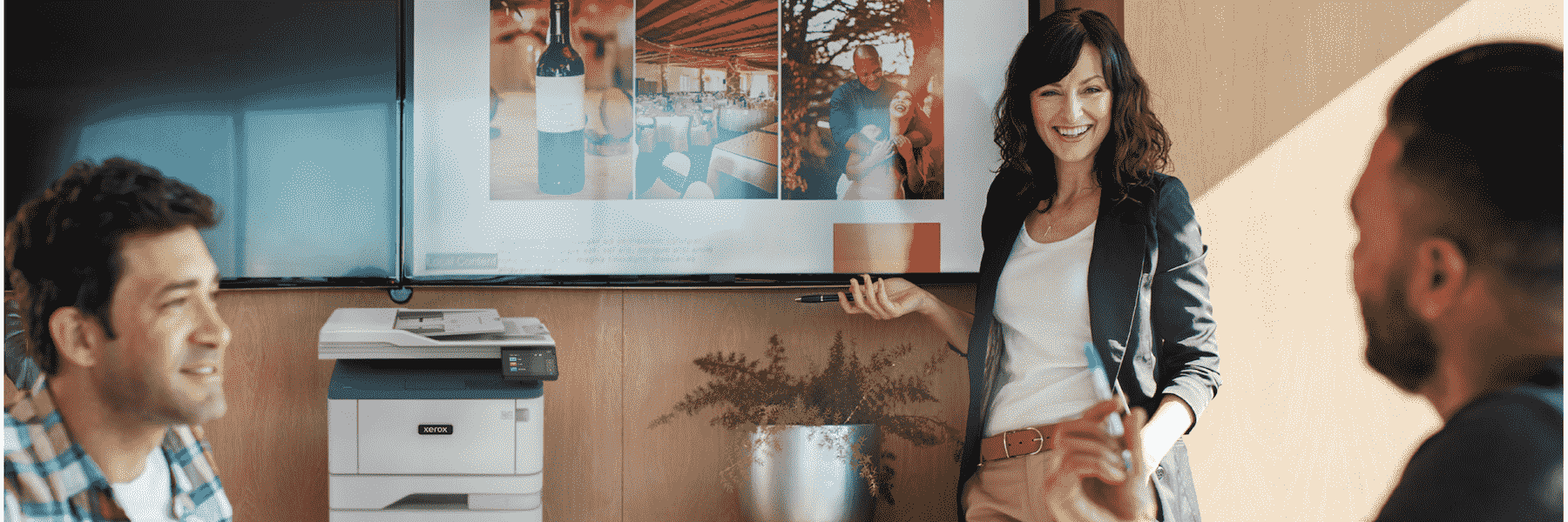 A group of people talking with the Xerox B305 in the background