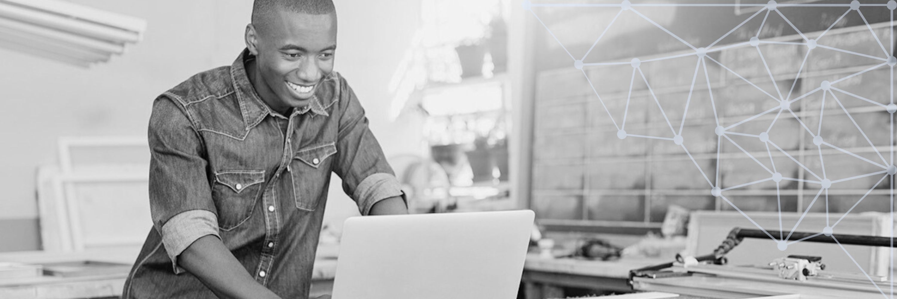 A person on a laptop in a work station