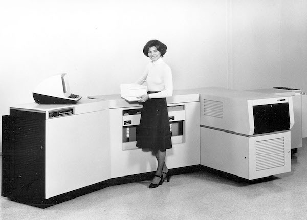 Woman standing near the Xerox 9700 printer