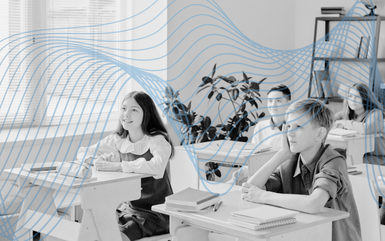 Teacher instructs student in the classroom.