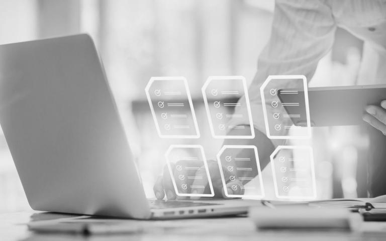 grayscale photo with computer and paper graphics