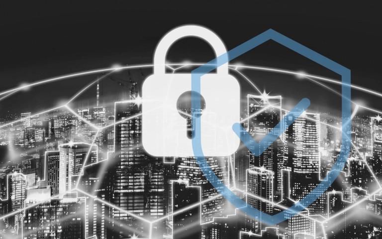 A city network is protected by a barrier with a white lock on top of it.