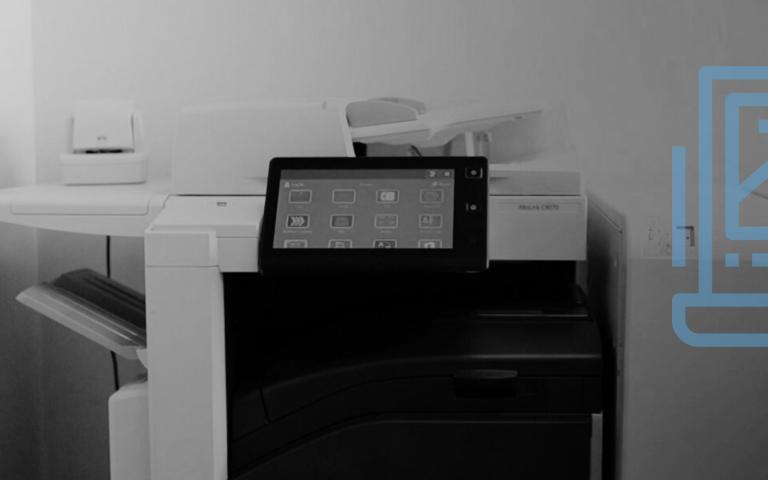 A picture of an office printer with a print media graphic on top