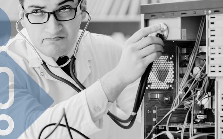 A doctor is checking the pulse of a computer with a graphic overlay of a heart and a warning sign