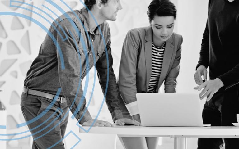 People stand around a computer waiting to print a color image.