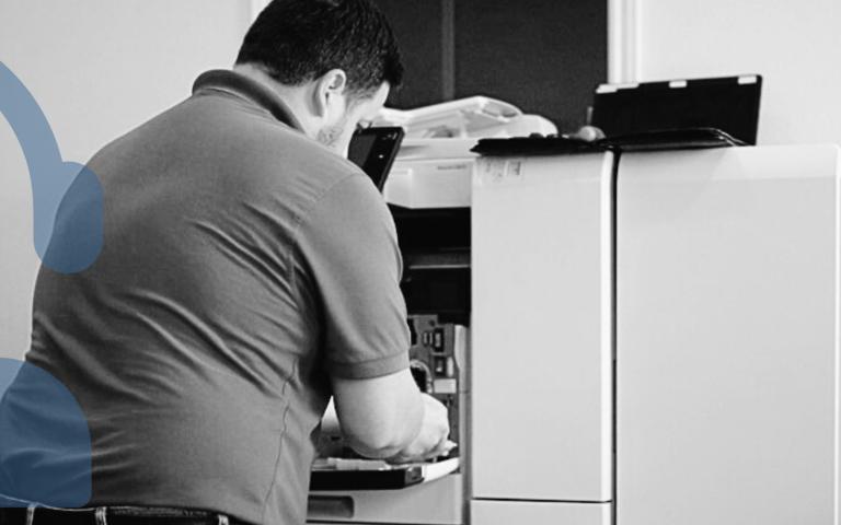 STPT Service Technician replacing a part on a printer