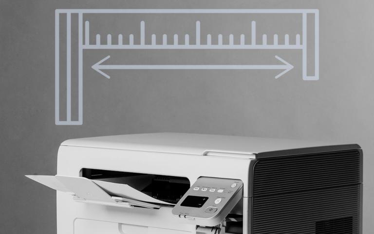 A printer with a graphic overlay of a measuring tape