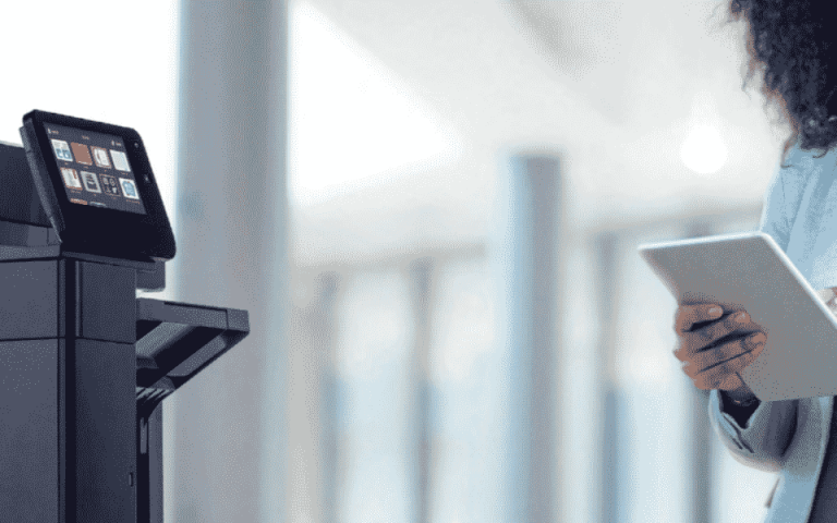 Person next to Xerox VersaLink B600 on a tablet