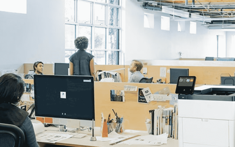 Two people next to the Xerox VersaLink C500 printer