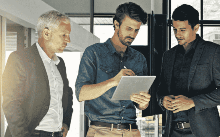 Three people standing near the Xerox VersaLink C605