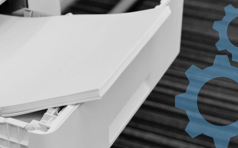 A printer paper tray open with paper