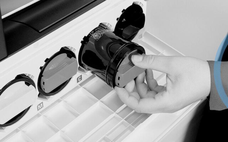 Person taking toner out of printer