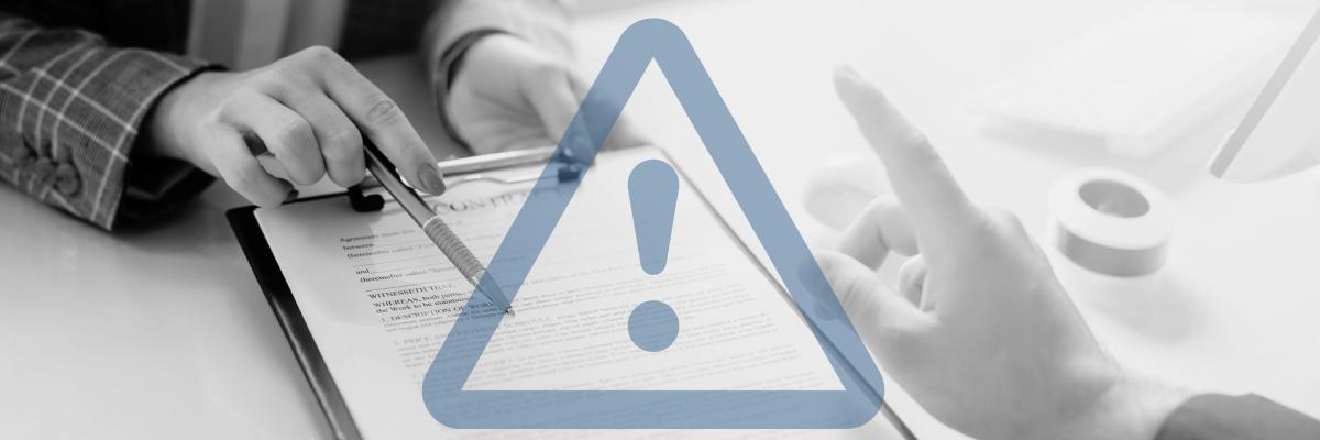 A person about to sign contract with graphic overlay of a warning sign