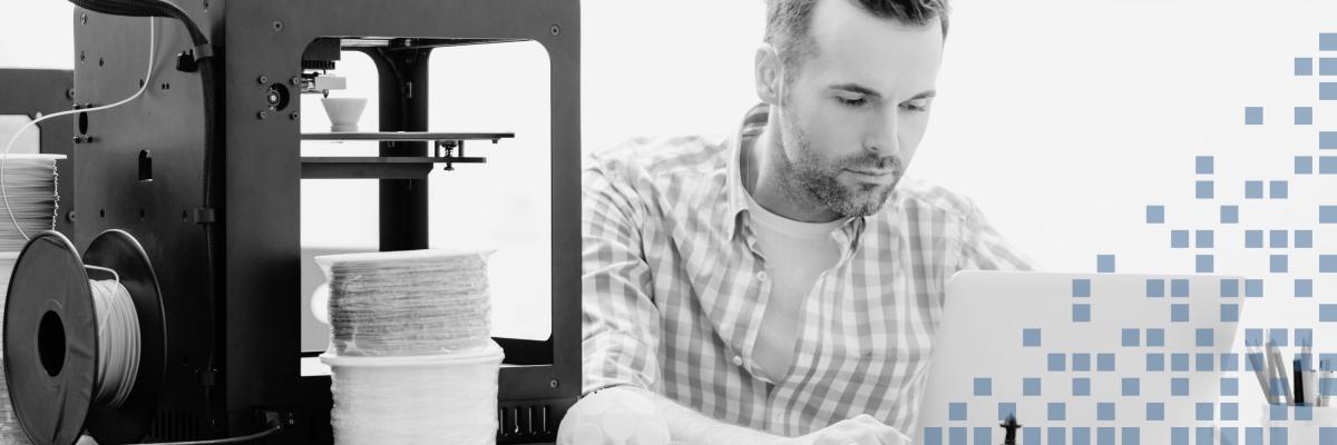 Man using a 3D printer and computer