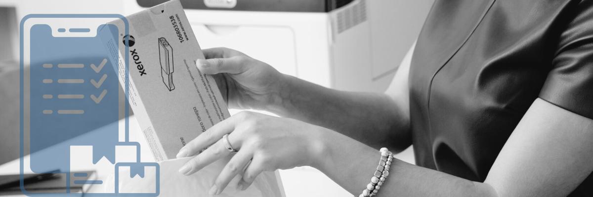 A woman opening a package of printer toner