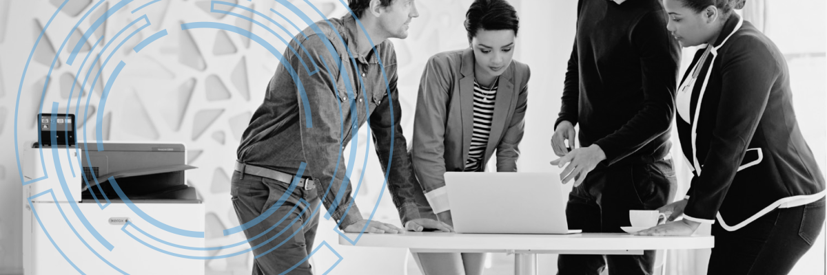 People stand around a computer waiting to print a color image.