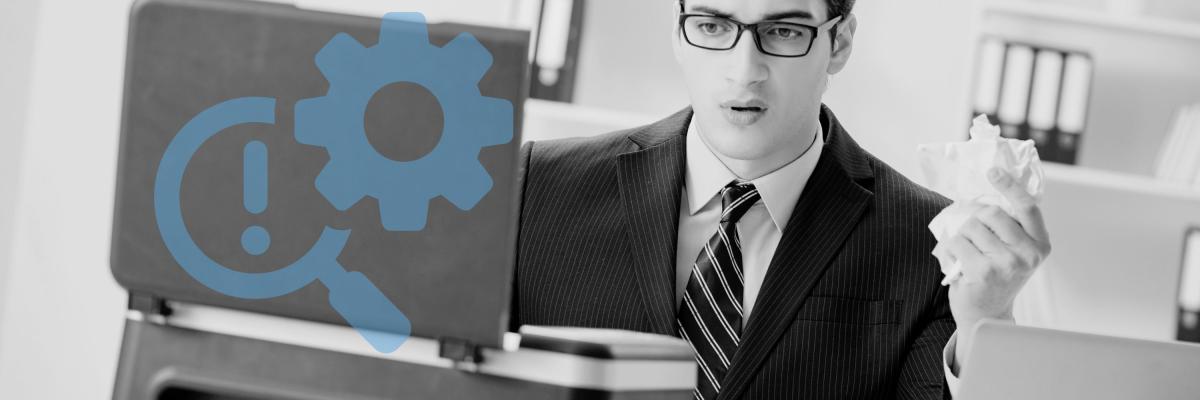 A man looking puzzled at a printer paper jam