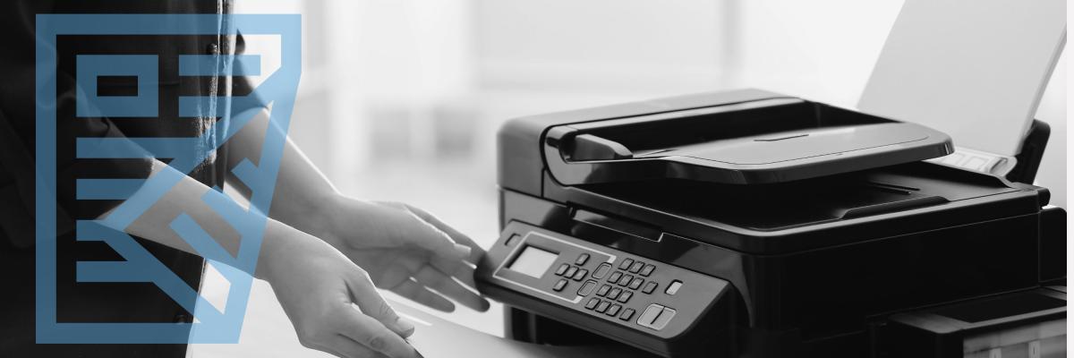 A person retrieving a document from a printer