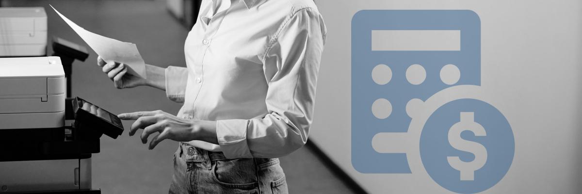 A woman holding a printer page in front of a printer