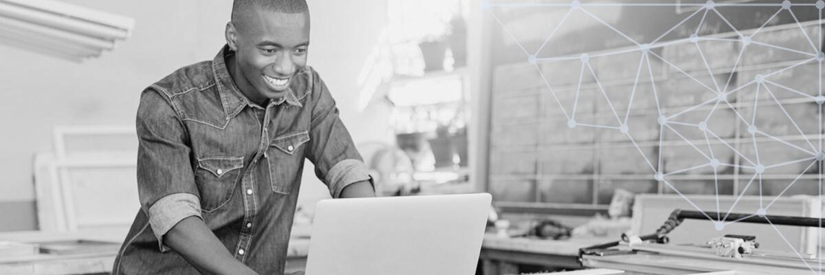 A person on a laptop in a work station