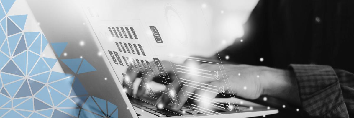 A man managing documents on a laptop