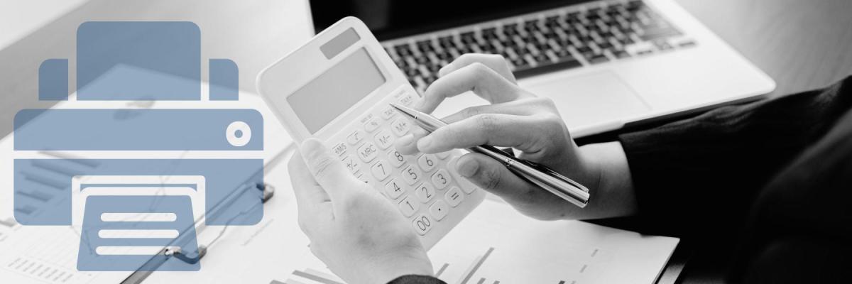 A person calculating a budget with calculator, paper, and laptop