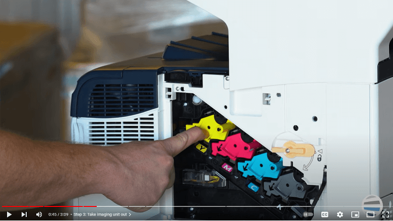 Screenshot of a printer technician taking out the imaging unit