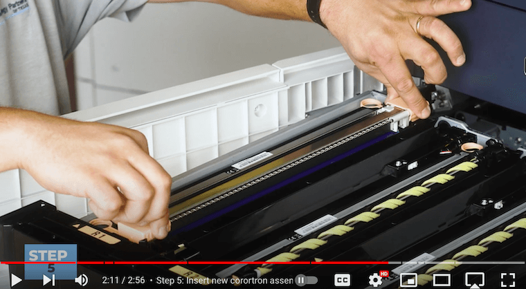 Printer technician inserts the new corotron assembly on the Xerox PrimeLink C9065