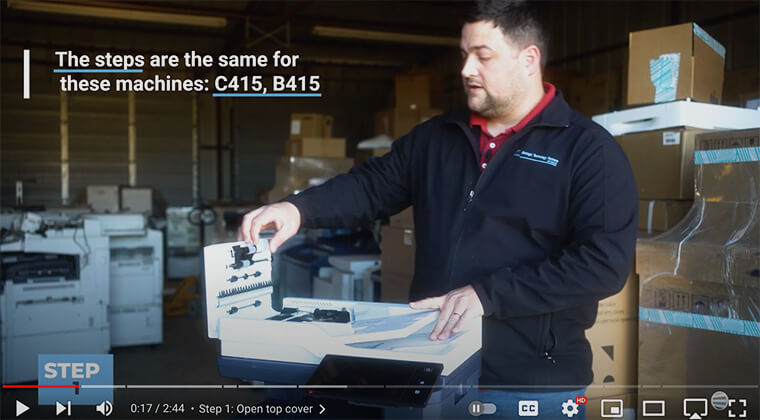 Printer technician opens the top cover of Xerox VersaLink C410/C415