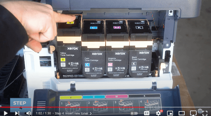 Printer technician inserts new toner cartridge on the Xerox C410/C415 to replace the toner