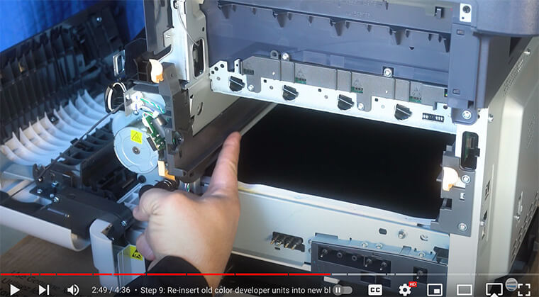 Printer technician points out grey slot for new imaging unit on the Xerox VersaLink C410/C415