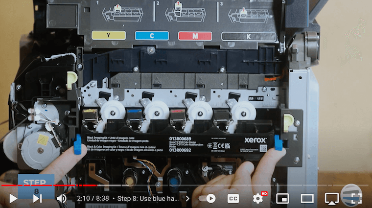 Printer technician lifts 2 blue handles of the Xerox C315 printer