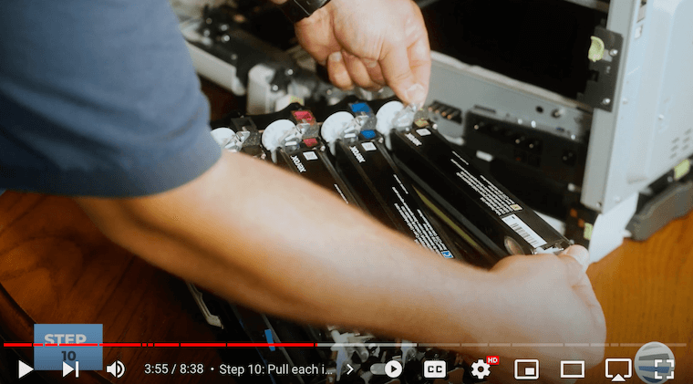 Printer technician removes the color developer units on top of the imaging kit tray on the Xerox C315 printer