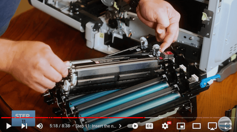 Printer technician inserts the new color developer units on the Xerox C315 printer