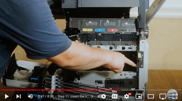 Printer technician inserts the new imaging unit assembly back on the Xerox C315 printer