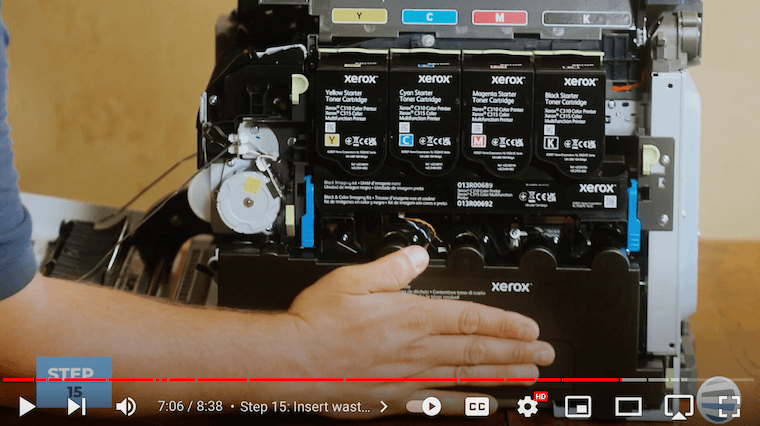 Printer technician reinstalls waste toner bottle on the Xerox C315 printer