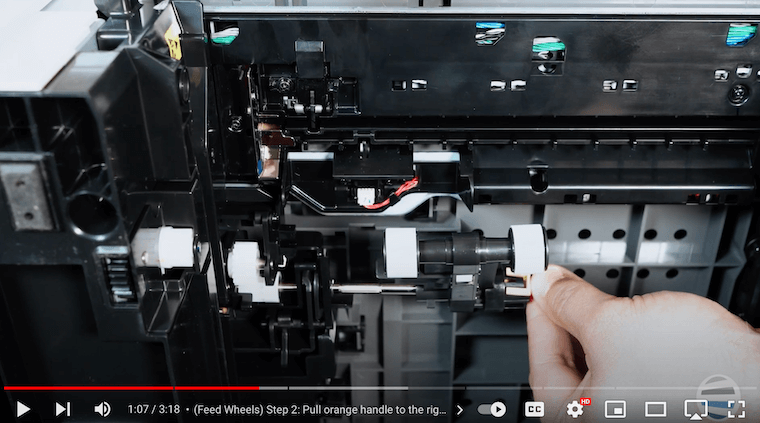 A printer technician removes the the feed wheels on the Xerox VersaLink B625