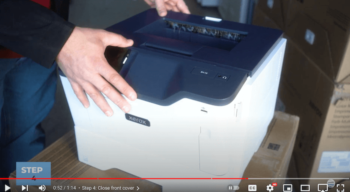 Printer technician closes the front cover on the Xerox B410/B415 printer to replace the toner