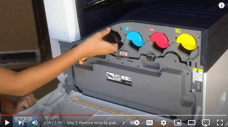 Printer technician removes old toner cartridge on the Xerox VersaLink C7030