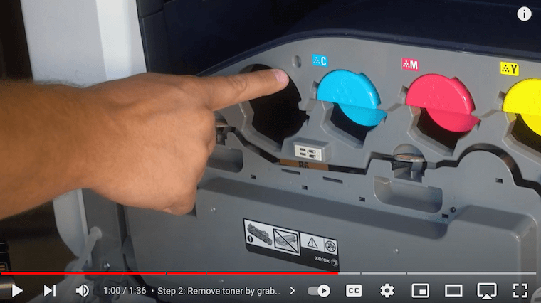 Printer technician inserts new toner and notes the hole it goes into on the Xerox VersaLink C7030