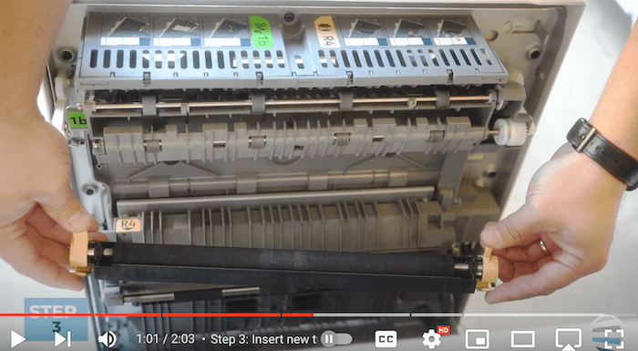 Printer technician inserts the new transfer roller on the Xerox AltaLink B8090