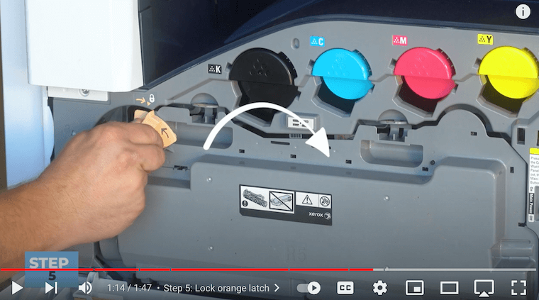 Printer technician locks the orange latch on the Xerox VersaLink C7030