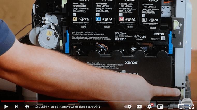 A printer technician finalizes waste toner bottle removal on the Xerox C315