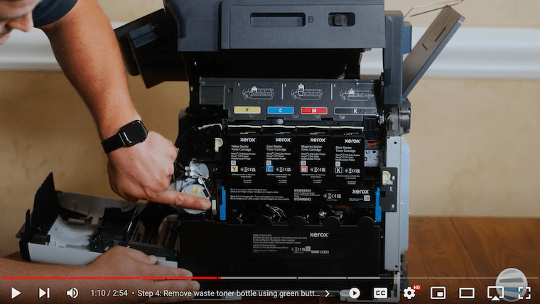 A printer technician removes the waste toner bottle on the Xerox C315