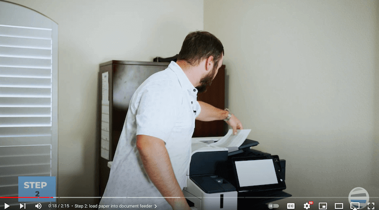 Xerox partner loads paper into document feeder for Summarizer App