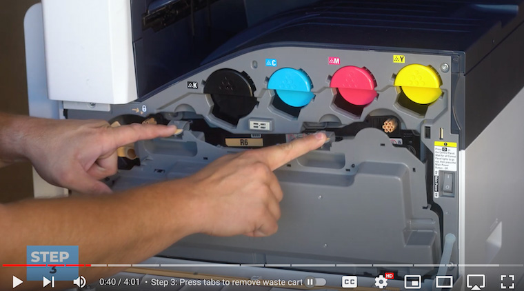 Printer technician removes waste cartridge from the Xerox VersaLink C7020/C7025/C7030 Printer