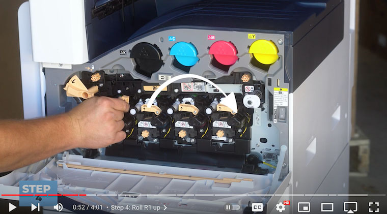 Printer technician lifts R1 orange lever on the Xerox VersaLink C7020/C7025/C7030 Printer